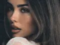 Zbliżenie na twarz Madison Beer, zmysłowe spojrzenie i delikatny uśmiech. Fani Madison Beer Polska czekają na jej powrót.