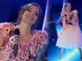Zuzanna Jurczak, znana jako piosenkarka, w kwiecistej sukni na scenie.