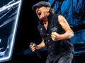 Brian Johnson z AC/DC w Polsce, w szczytowej formie, śpiewa z mikrofonem w dłoni.